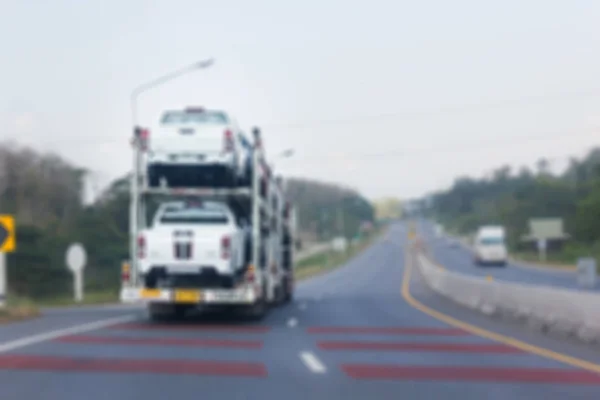 Blurred background truck transfer cars, car transportation