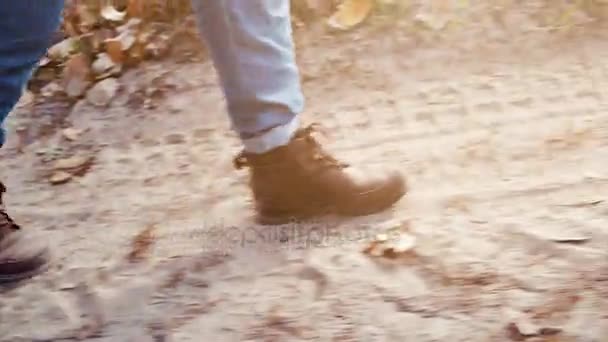 Unknown person walking along the dusty road. Foot close up — Stock Video