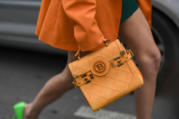 Paris, France - February 28, 2020: Orange suede Balmain handbag - streetstylefw2020