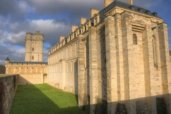 Donjon with west side of the Chateau de Vincennes in a low winter sun, seen from the street