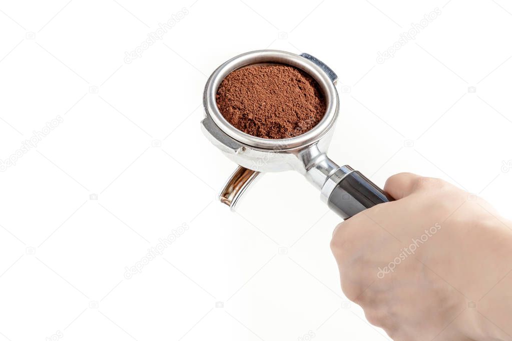 Barista hold the portafilter with coffee ground, prepare to tamp