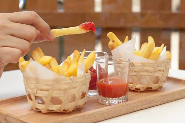 Eating french fries dipping with ketchup and chili sauce — Stock Photo, Image