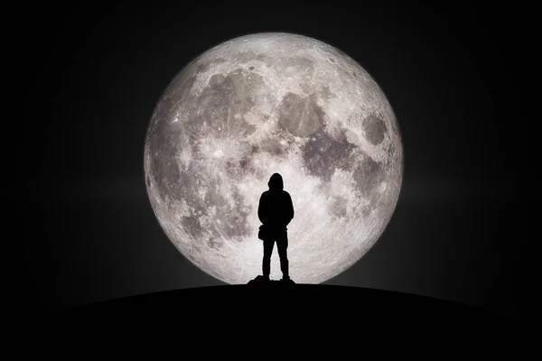 Silhouette of man  Looking at the moon with hope Fulfillment in love. Elements of this image furnished by NASA.