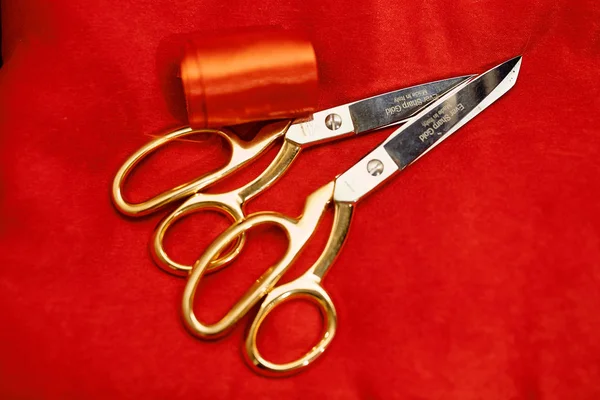 Photo of silver scissors with golden handle