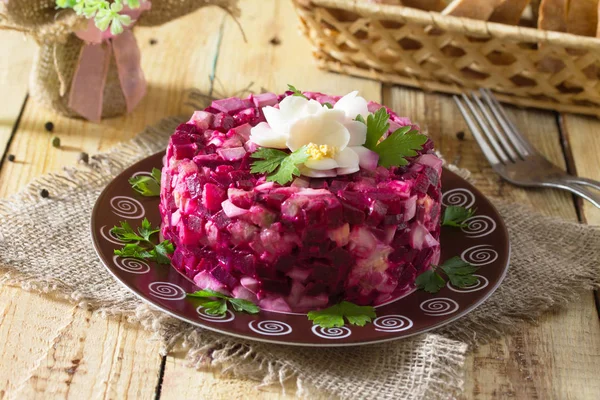 Holiday an appetizer salad (from beetroot, eggs, herring) on the — Stock Photo, Image