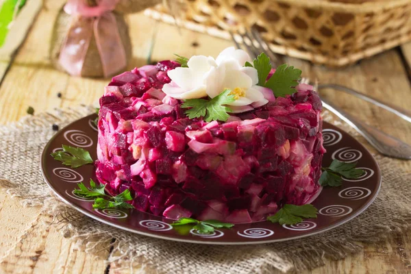Holiday an appetizer salad (from beetroot, eggs, herring) on the — Stock Photo, Image