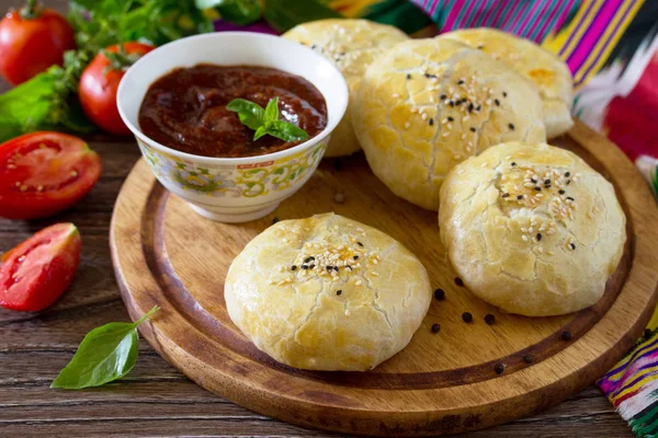 Pies fried samosa on a wooden table, the national dish of Caucas