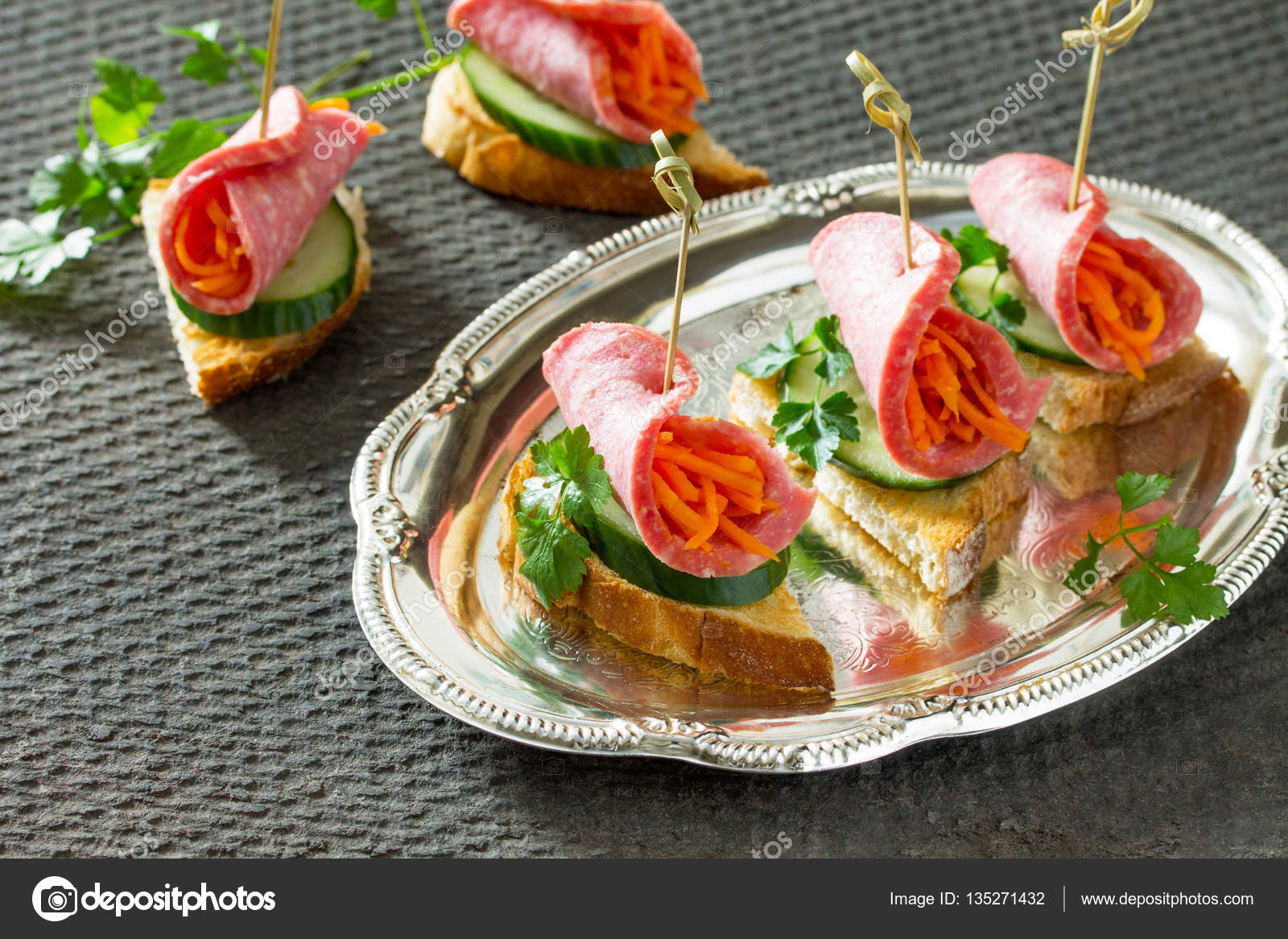 Holiday appetizer: Canapes on crispy bread with cucumber, carrot