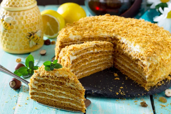 Dulce pastel de miel en capas caseras en una mesa de madera con pasas y —  Fotos de Stock