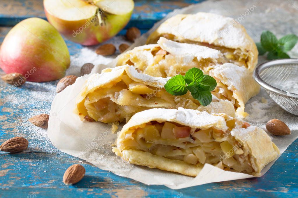 Homemade apple strudel with fresh apples, nuts and powdered suga