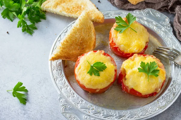 Stuffed tomatoes. Tomatoes baked with cheese and chicken, served