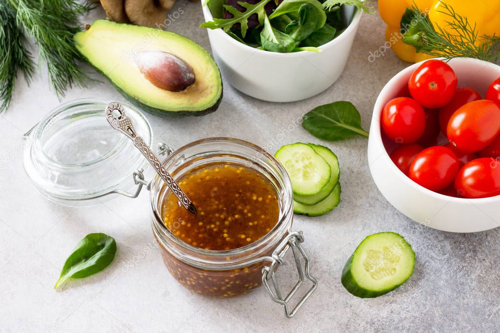 Superfoods and homemade salad dressing vinaigrette with mustard,