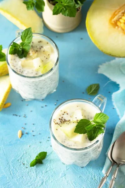 Pudín saludable en un vaso con chía y melón y sobre piedra azul —  Fotos de Stock