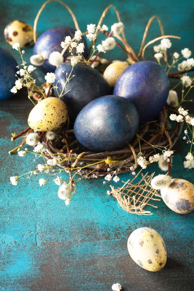 Classic blue 2020. Blue easter eggs in a nest on a blue stone or