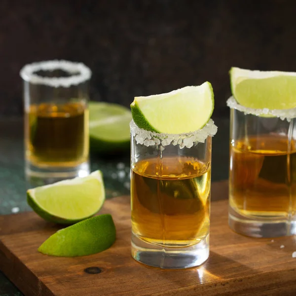 Gold Tequila. Mexican Gold Tequila shot with lime and salt on da