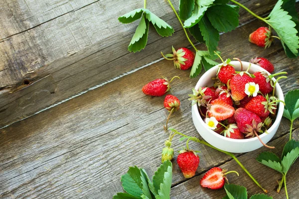 Verse aardbeien in een kom op een houten rustieke tafel. Kopieerspaak — Stockfoto