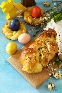 Easter sweet bread with colored eggs and traditional Italian Eas