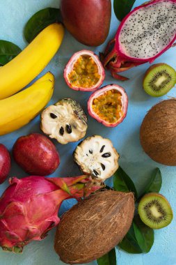Meyve arkaplanı. Olgun, sulu, egzotik Asya yaz mevsimsel meyveleri mavi taştan bir arka planda. Üst görünüm düz arkaplan. 
