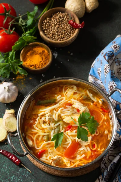 Tukpa soup Indian cuisine. Hot noodle soup with chicken ginger, cilantro and garlic in a bowl on a dark tabletop. — Stock Image Tukpa Soup Indian Cuisine Hot Noodle Soup Chicken Ginger Cilantro Royalty Free Stock Images