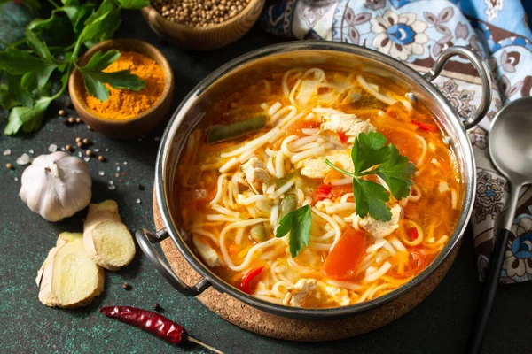 Tukpa soup Indian cuisine. Hot noodle soup with chicken ginger, cilantro and garlic in a bowl on a dark tabletop. — Stock Image Tukpa Soup Indian Cuisine Hot Noodle Soup Chicken Ginger Cilantro Stock Image