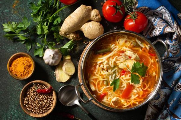 Tukpa soup Indian cuisine. Hot noodle soup with chicken ginger, cilantro and garlic in a bowl on a dark tabletop. Top view flat lay background. — Stock Image Tukpa Soup Indian Cuisine Hot Noodle Soup Chicken Ginger Cilantro Stock Photo