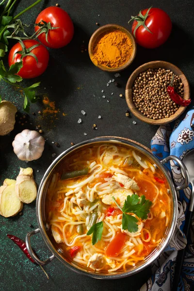 Tukpa soup Indian cuisine. Hot noodle soup with chicken ginger, cilantro and garlic in a bowl on a dark tabletop. Top view flat lay background. — Stock Image Tukpa Soup Indian Cuisine Hot Noodle Soup Chicken Ginger Cilantro Stock Picture