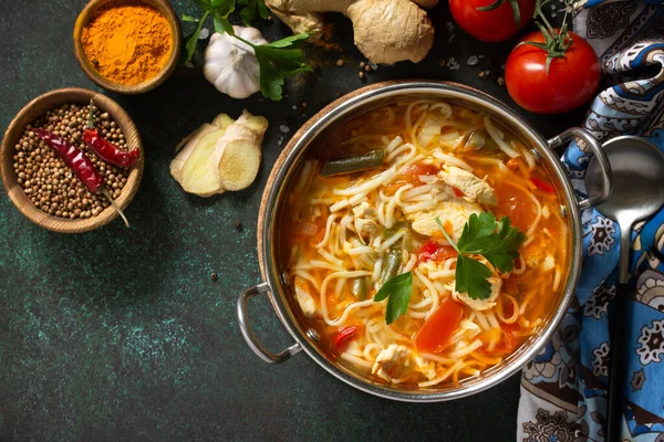 Tukpa soup Indian cuisine. Hot noodle soup with chicken ginger, cilantro and garlic in a bowl on a dark tabletop. Top view flat lay background. Copy space. — Stock Image Tukpa Soup Indian Cuisine Hot Noodle Soup Chicken Ginger Cilantro Royalty Free Stock Images
