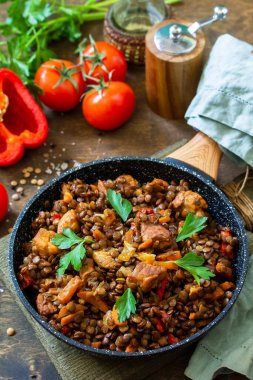 Hint mutfağı. Geleneksel Hint baharatlı yeşil mercimek et, baharat, ahşap bir masada dökme demir tavada otlar..