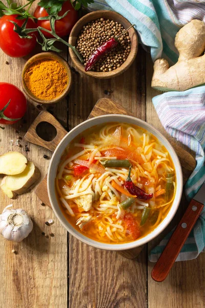 Tukpa soup of Indian cuisine. Hot noodle soup with chicken, ginger, cilantro and spices on a deyven wooden table. Top view flat lay background. Copy space — Stock Image Tukpa Soup Indian Cuisine Hot Noodle Soup Chicken Ginger Cilantro Stock Picture