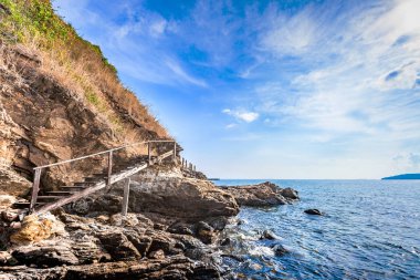 Kayalar ve çayır bulutlu mavi gökyüzü güzel deniz manzarası