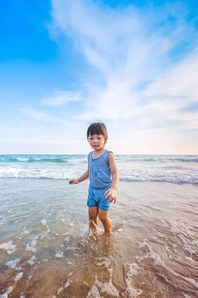 Little girl playing on the beach in sunset — Stock Photo, Image