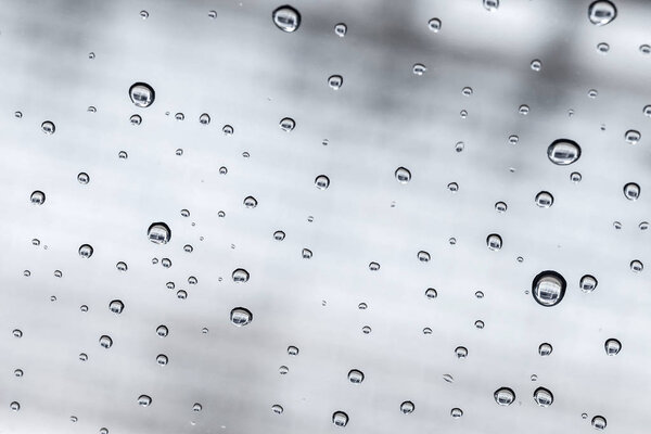 Raindrops on a car windshield after raining