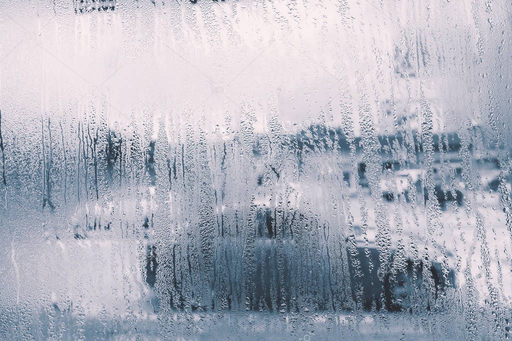 raindrops on glass window in rainy season