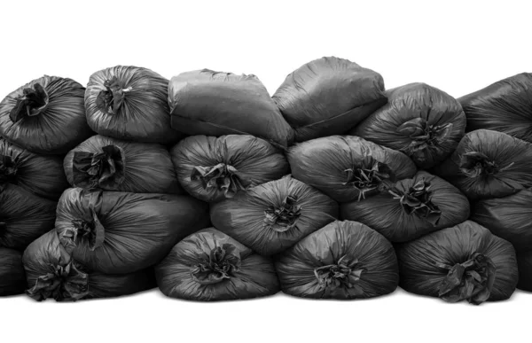 Black trash bag pile up and isolated on white background — Stockfoto