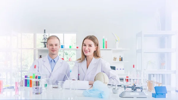 Two scientists working in chemical laboratory