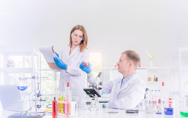 Two scientists working in chemical laboratory