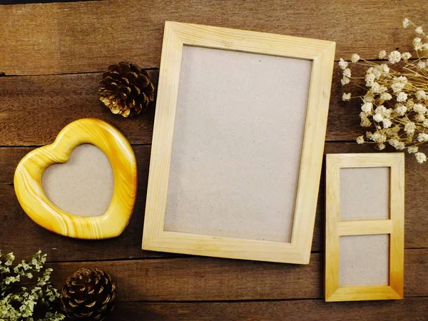 Blank photo frames on the table wooden background — Stock Photo, Image