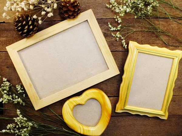 Blank photo frames on the table wooden background — Stock Photo, Image