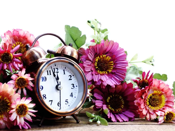 Spring time with alarm clock and artificial flowers bouquet background — Stock Photo, Image