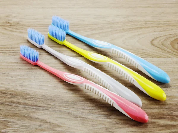 Top view toothbrushes on wooden background with space copy — Stock Photo, Image