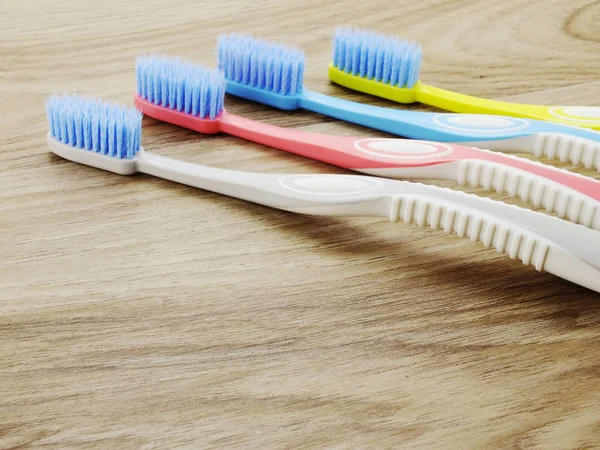 Top view toothbrushes on wooden background with space copy — Stock Photo, Image