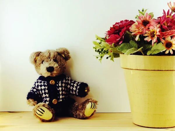 Oso tedy con despertador y ramo de flores sobre fondo de madera —  Fotos de Stock