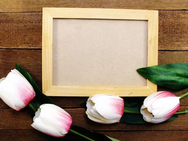 Wooden photo frames space background decorate with artificial tulip flowers — Stock Photo, Image