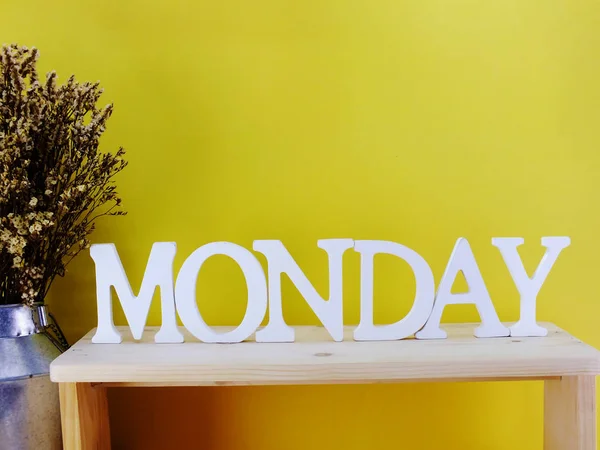 hello monday wooden letter alphabet on wooden background