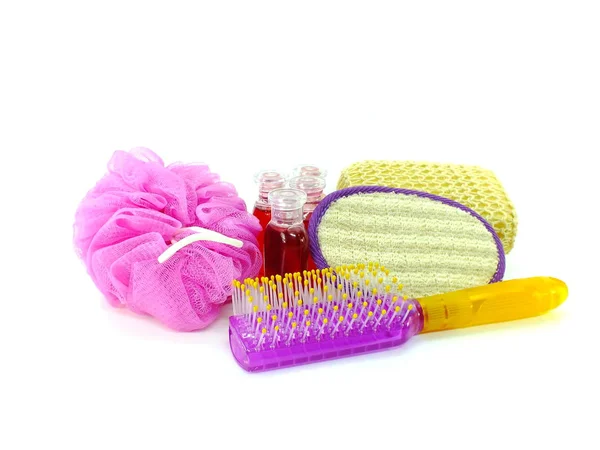 plasstic soft puff and shower gel with shower accessories on wooden background