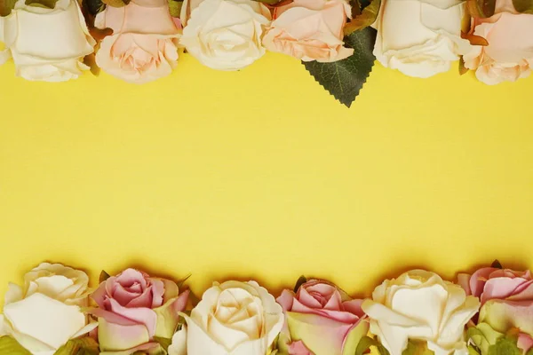 Roses flower bouquet border frame with space copy on yellow background
