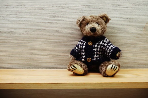 Teddy Bear with space copy on wooden shelves background