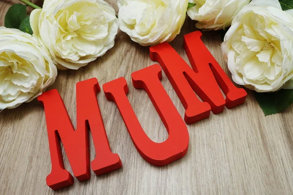 Mother's day with mum alphabet letter on wooden background