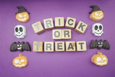Trick or treat alphabet letters top view on purple background
