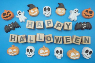Happy Halloween alphabet letters top view on blue background